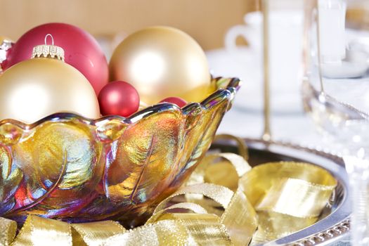 Red and gold ornaments in bowl