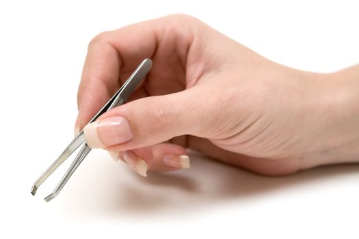 Woman holding a pair of tweezers. White background.