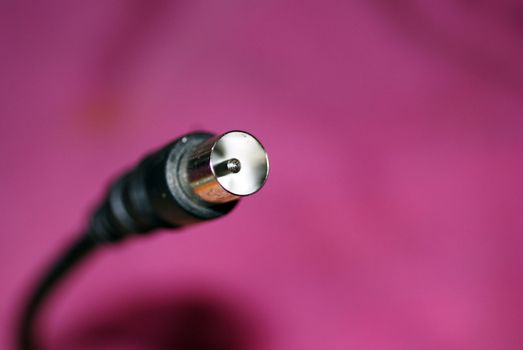 A close up photograph of the plug of an antenna cable.