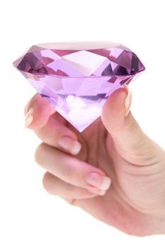 Female hand holding a precious gem. Isolated on a white background.