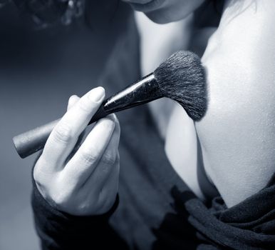Brush for a make-up in a female hand