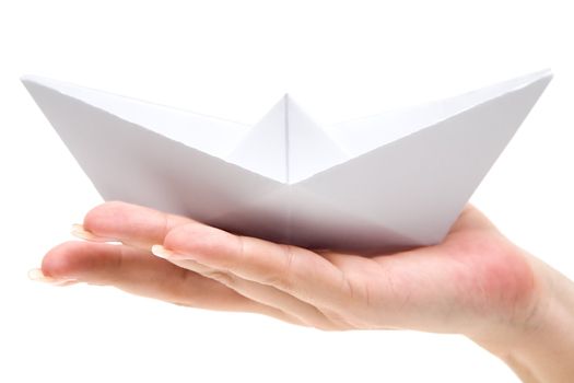 Woman holding a folded paper boat. Isolated on a white background.