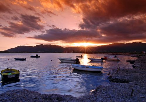 Beautiful sunset over harbor with dramatic sky on Sardinia