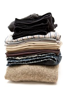 Stack of various garments. White background.