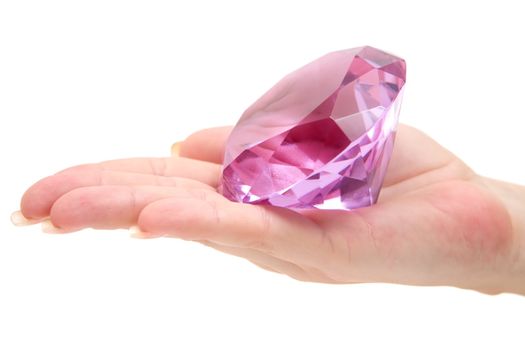 Woman holding a pink gemstone. Isolated on a white background.