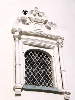 Window of the old church with pigeons shadow