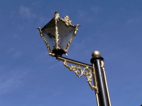 Aged gilded street lamp