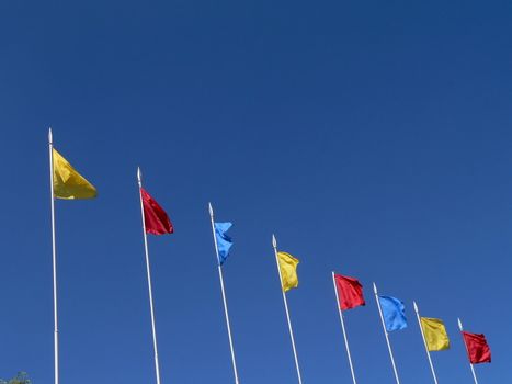 Colored flags on sky background