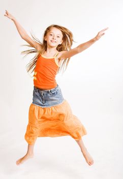 little girl jumps on a white background

