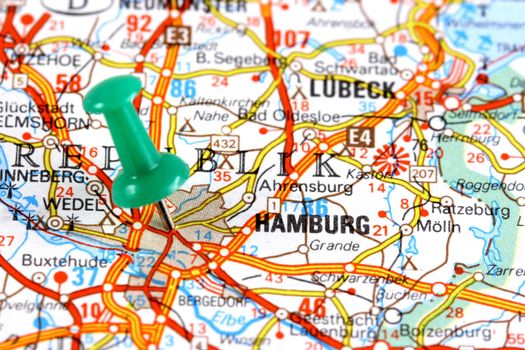 Hamburg, Germany, Europe. Push pin on an old map showing travel destination. Selective focus.