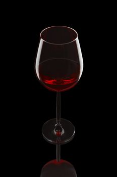 Red wine glass on the black background