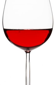 Isolated red wine glass with wine over a white background.