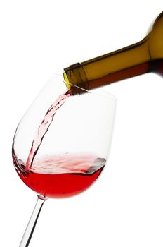 Pouring red wine to glass, clipping path included.