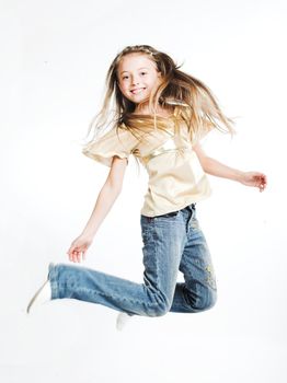little girl jumps on a white background

