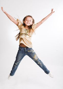 little girl jumps on a white background

