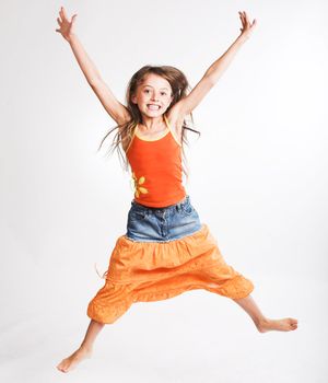 little girl jumps on a white background

