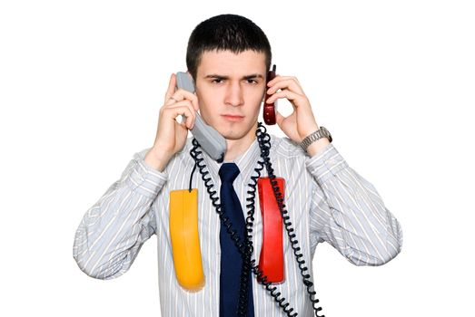 The young man speaks simultaneously by two phones
