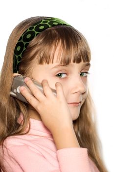 The girl talks on a cellular telephone
