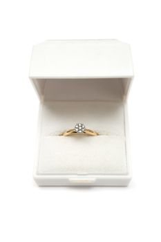 Diamond ring in a white giftbox. White background.