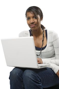 A beautiful female student sitting browsing with her laptop.
