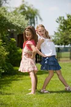 Two young girls having fun posing as real models
