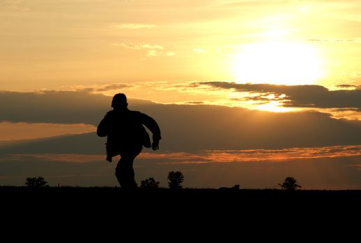The running boy on a sunset