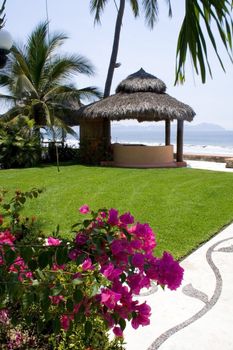 Beautiful Cabana surounded by flowers and ocean