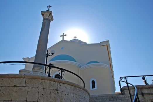 Greek church with 3 crosses in the setting sun 