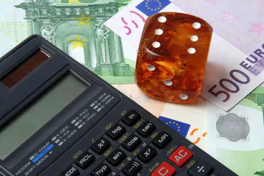 Hazard of business - calculator with dice on money background