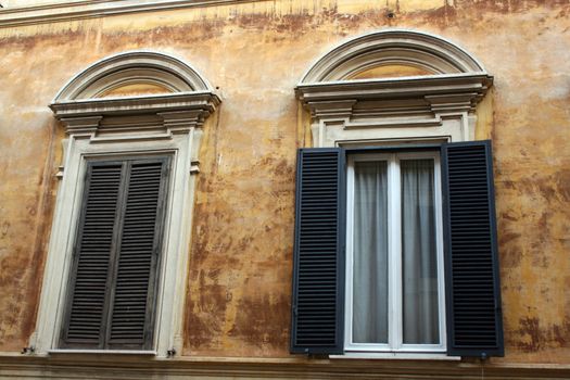 two roman windows, one open one closed