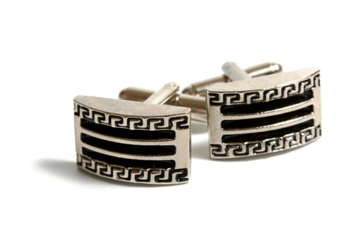 a pair of stainless steel cufflinks on white
