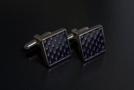 stainless steel cufflinks on the black background