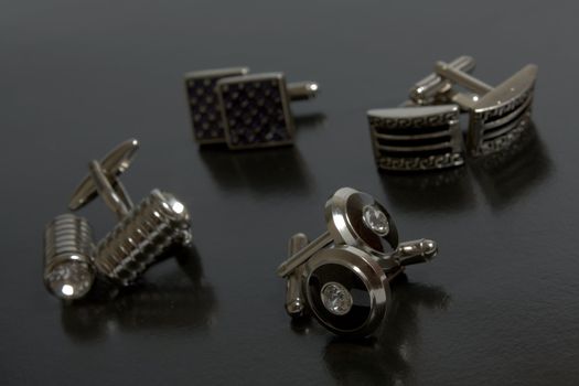 stainless steel cufflinks on the black background