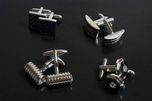 stainless steel cufflinks on the black background