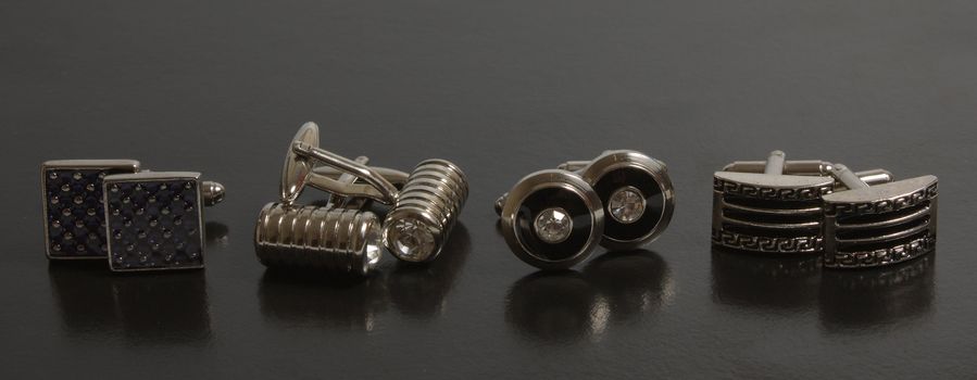 stainless steel cufflinks on the black background