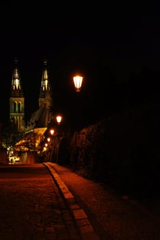 Cathedral of Peter and Paul in Prague in the night with a road decorated by shining lanterns. Looks nostalgic and full of atmosphere