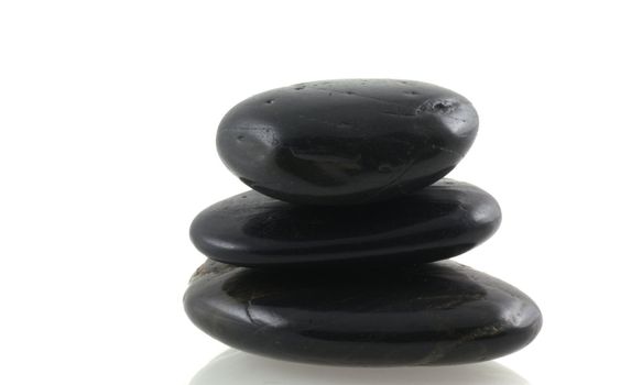 Pile of black stones on a white background.