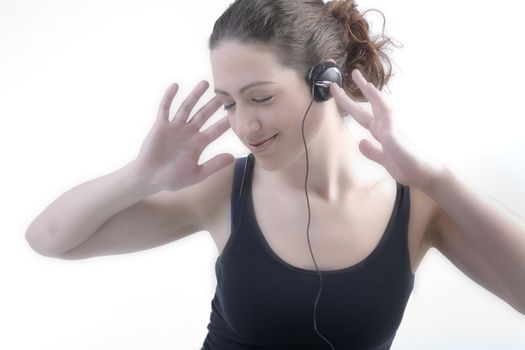 Portrait of a woman with long curly hair listening to music on her head[hone