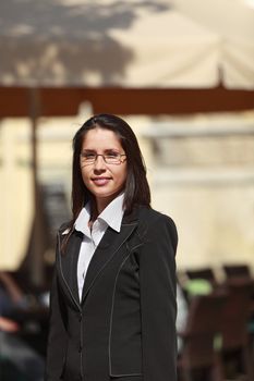 Portrait of a young woman with glasses in the city.