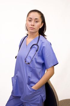 Pretty Hispanic nurse isolated on white on phone with file folder