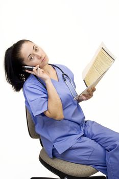Pretty Hispanic nurse isolated on white on phone with file folder