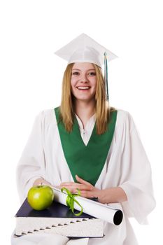 A teenage graduate with a book apple and diploma(teachers pet concept)