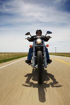 A biker speeding on a rural road