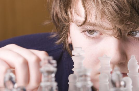 Young boy concentrating while playing a game of chess