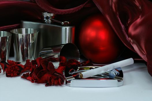 still life in crimson tints with shpere, flask, steell cups, colored dried plants, drapery and other objects