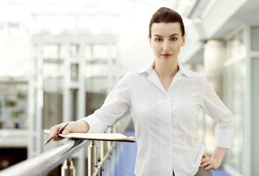 Portrait of young woman standing with calendar 