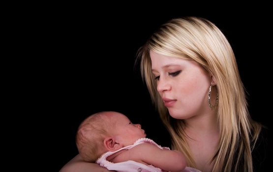 A young mother holding her 8 day old newborn girl