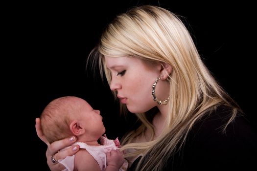 A young mother holding her 8 day old newborn girl