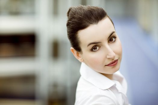 Portrait of young woman in modern office building environment