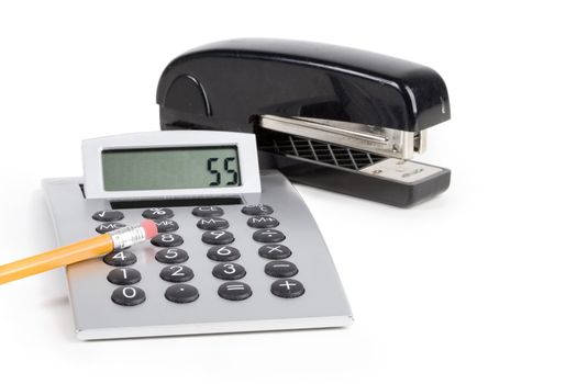 Office tools, calculator and stapler over white